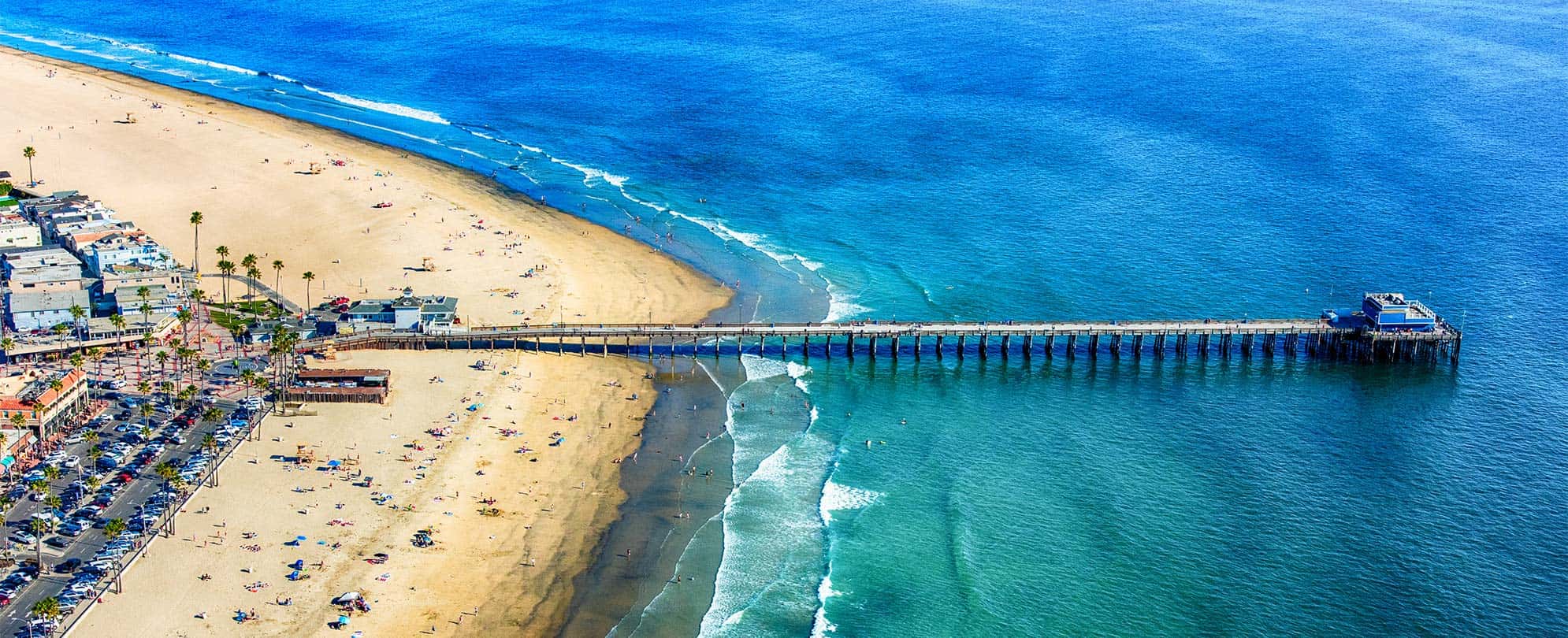 Sand, ocean, and pier at Newport Beach in California.