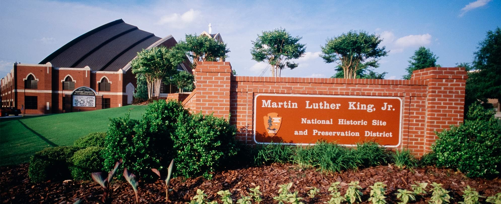 A brick wall with an orange sign, for the Martin Luther King Jr. National Historical Park.