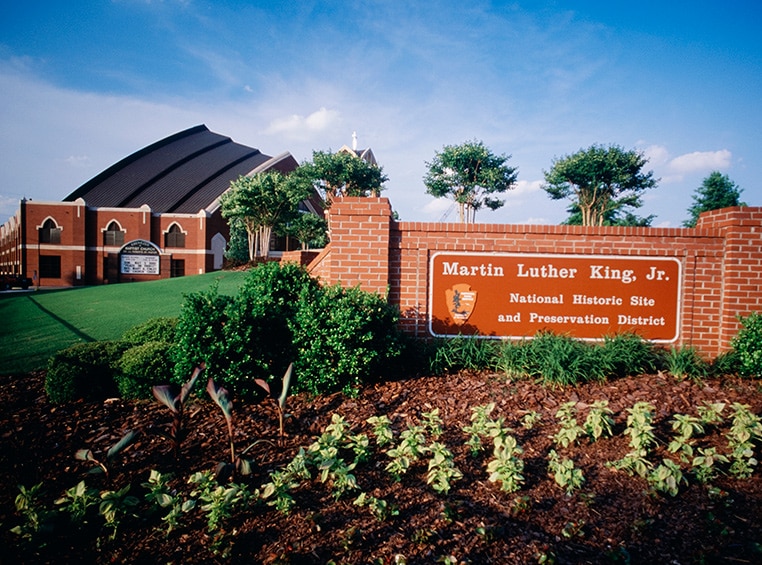 A brick wall with an orange sign, for the Martin Luther King Jr. National Historical Park.