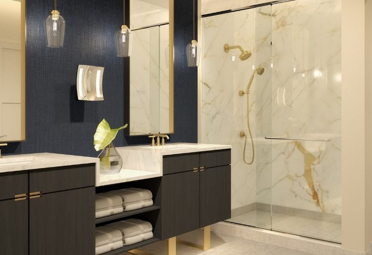 A presidential bathroom with dark cabinets and polished brass hardware.