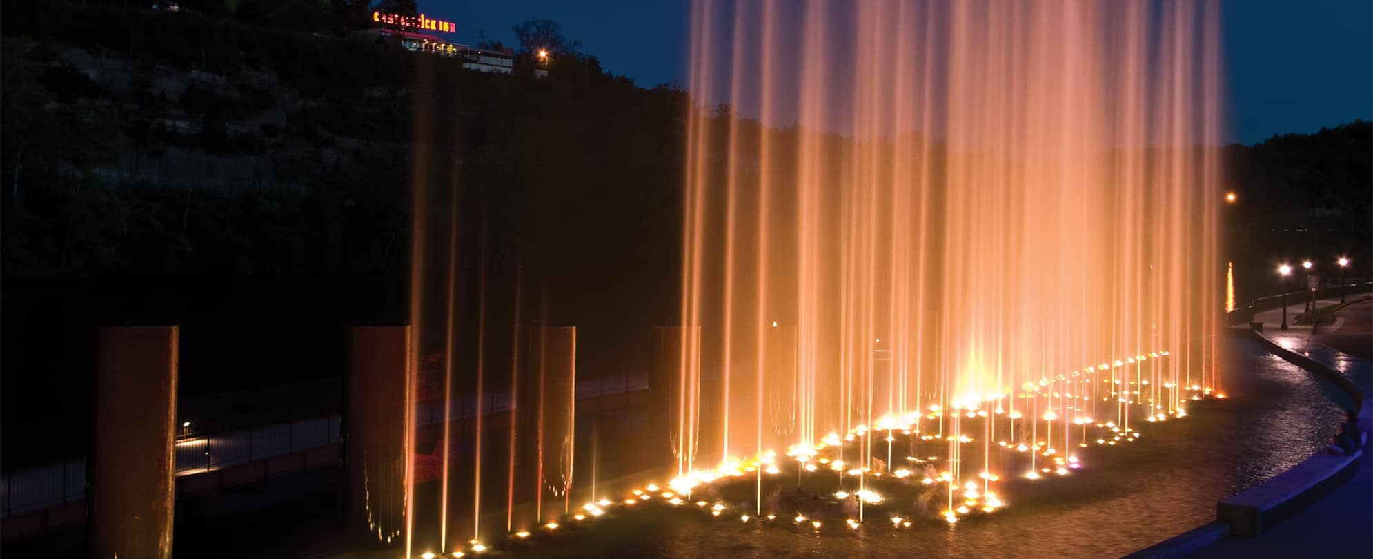 Lights pointing up into the air from a fountain in Branson, Missouri.