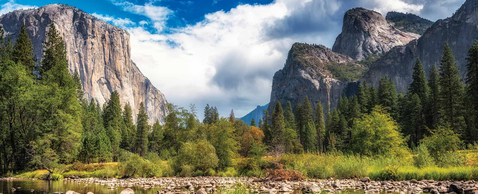 A view of the giant granite cliffs from the river valley below at Yosemite National Park in California