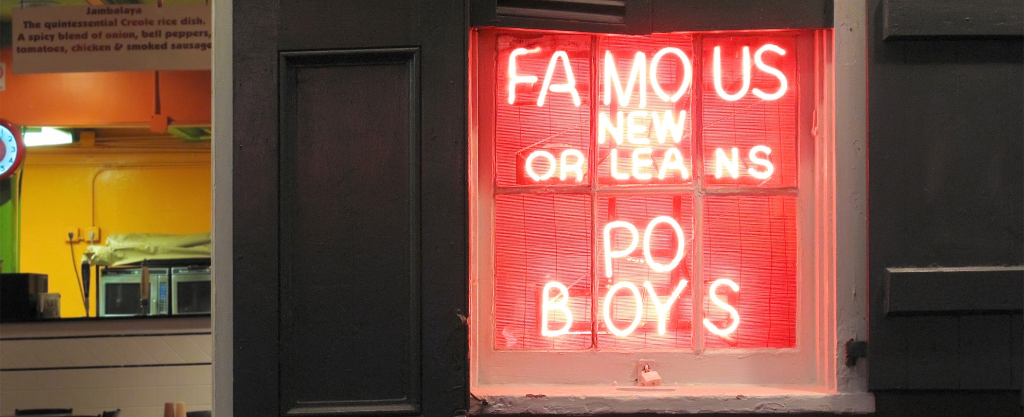 A neon sign that reads "famous New Orleans Po Boys."