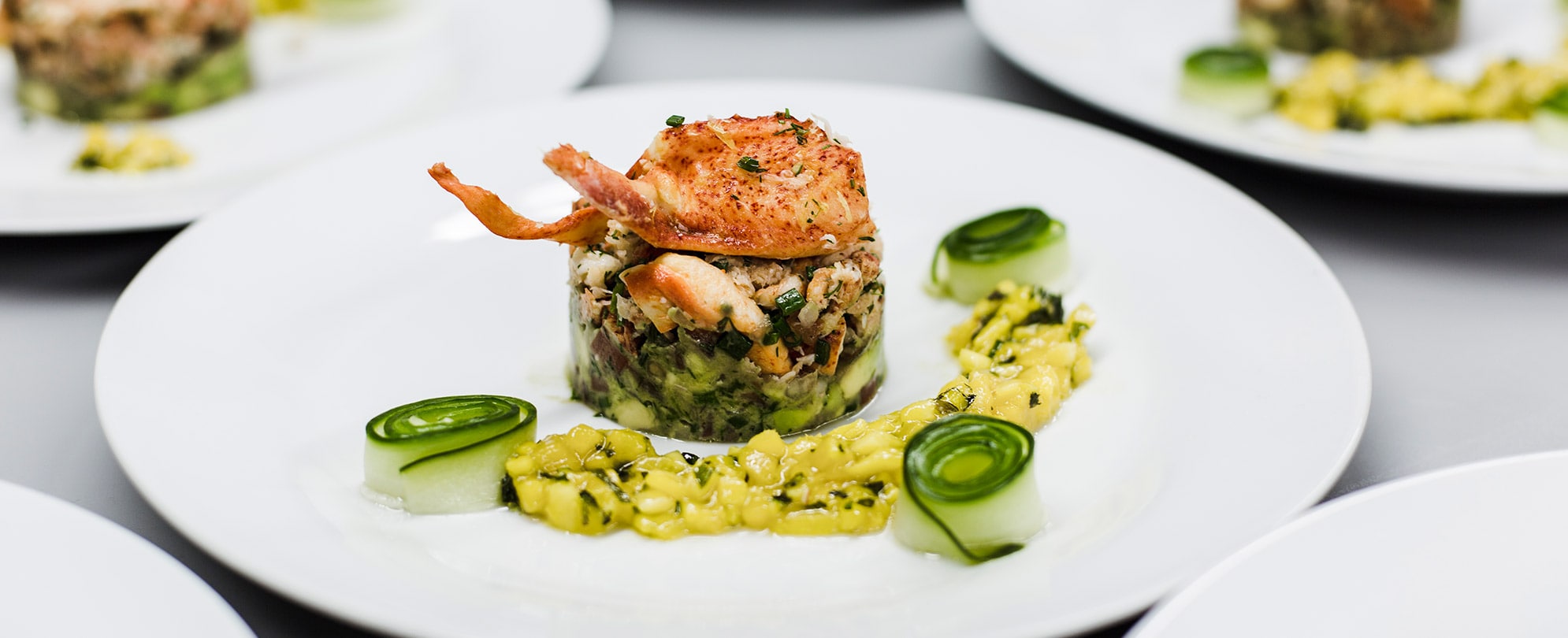 A vegetable lobster risotto food plate at a restaurant in Little Italy in California.