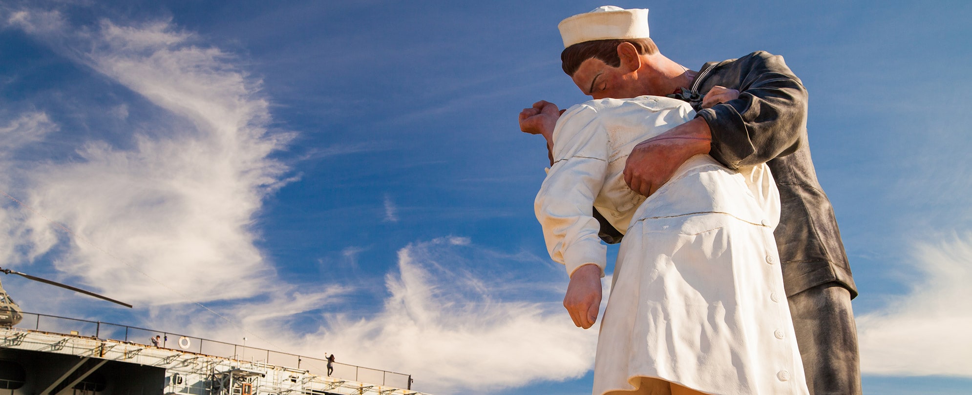 A statue of a sailor dipping and kissing a woman at the USS Midway Museum in San Diego, California.