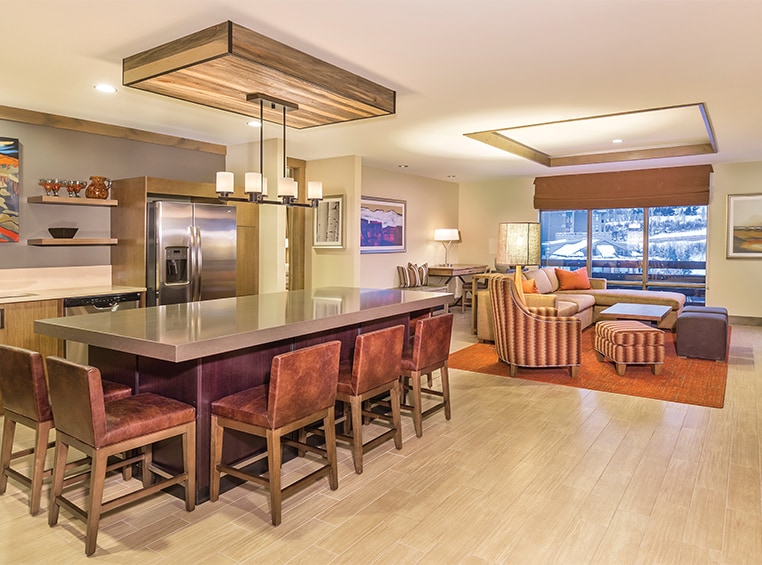 The kitchen island and living area of a Presidential Reserve suite at Club Wyndham Resort at Avon.
