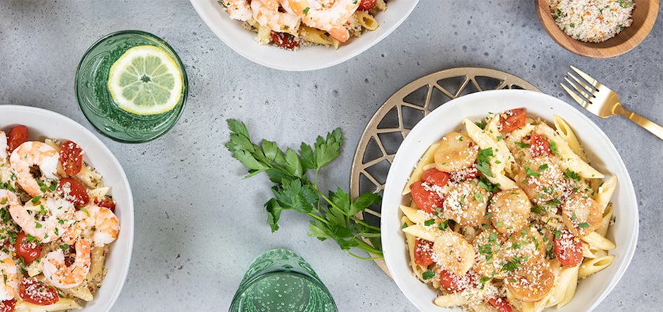 Home Chef meals in bowls with pasta, tomatoes, shrimp, sausage and cheese.