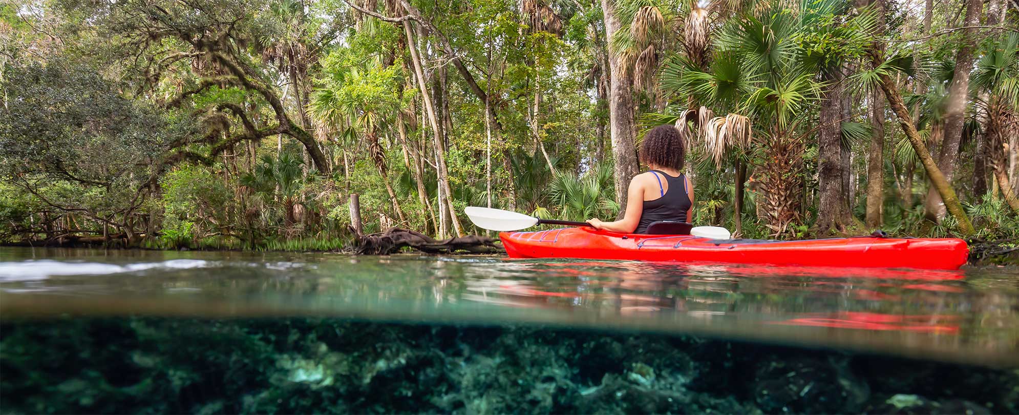 A woman kayaks along a natural spring near Orlando, Florida.