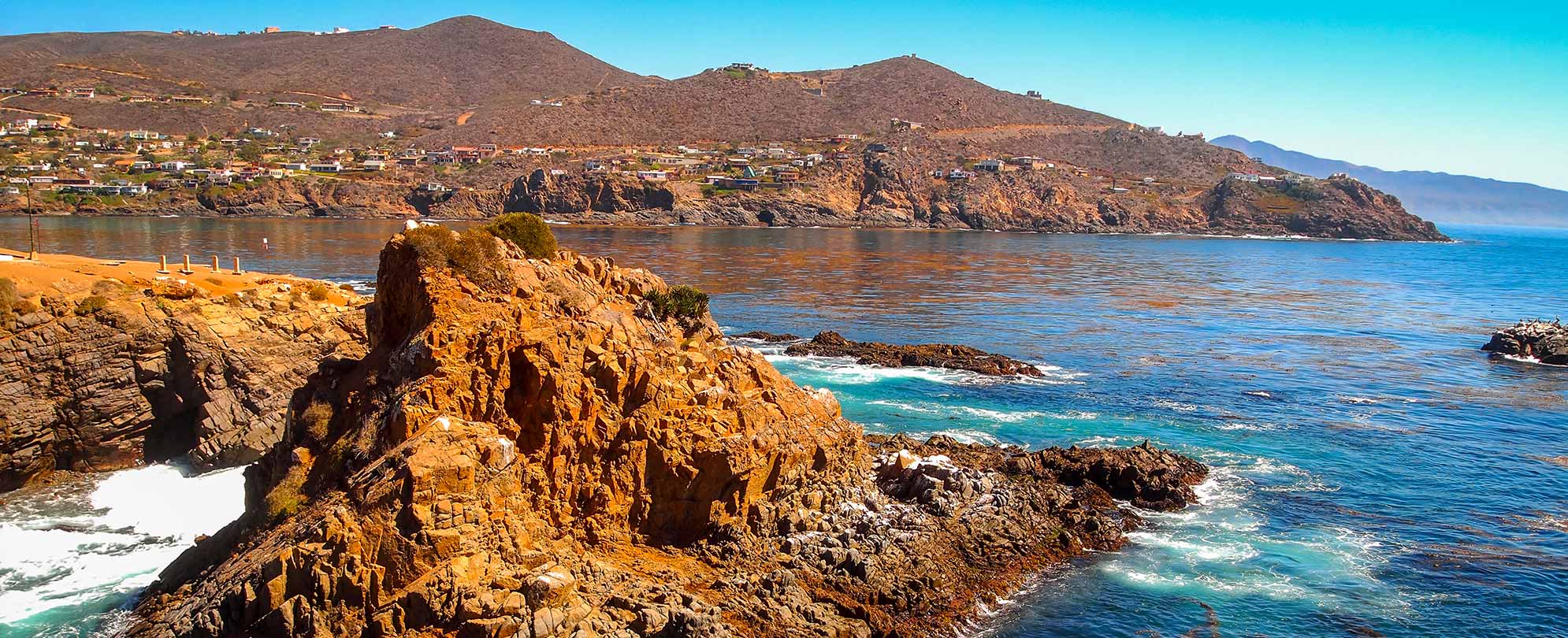 Sparkling blue water and a rugged mountain range in Baja, Mexico with Club Wyndham.