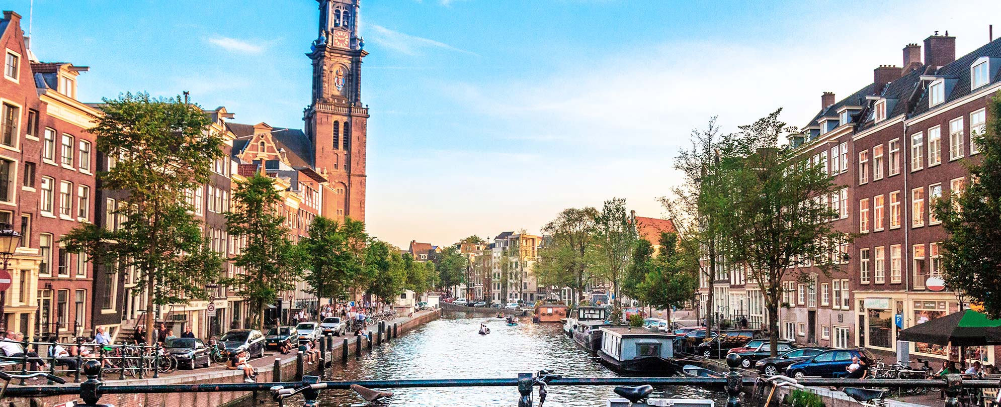 Buildings and clocktower along a canal in Amsterdam, Netherlands.