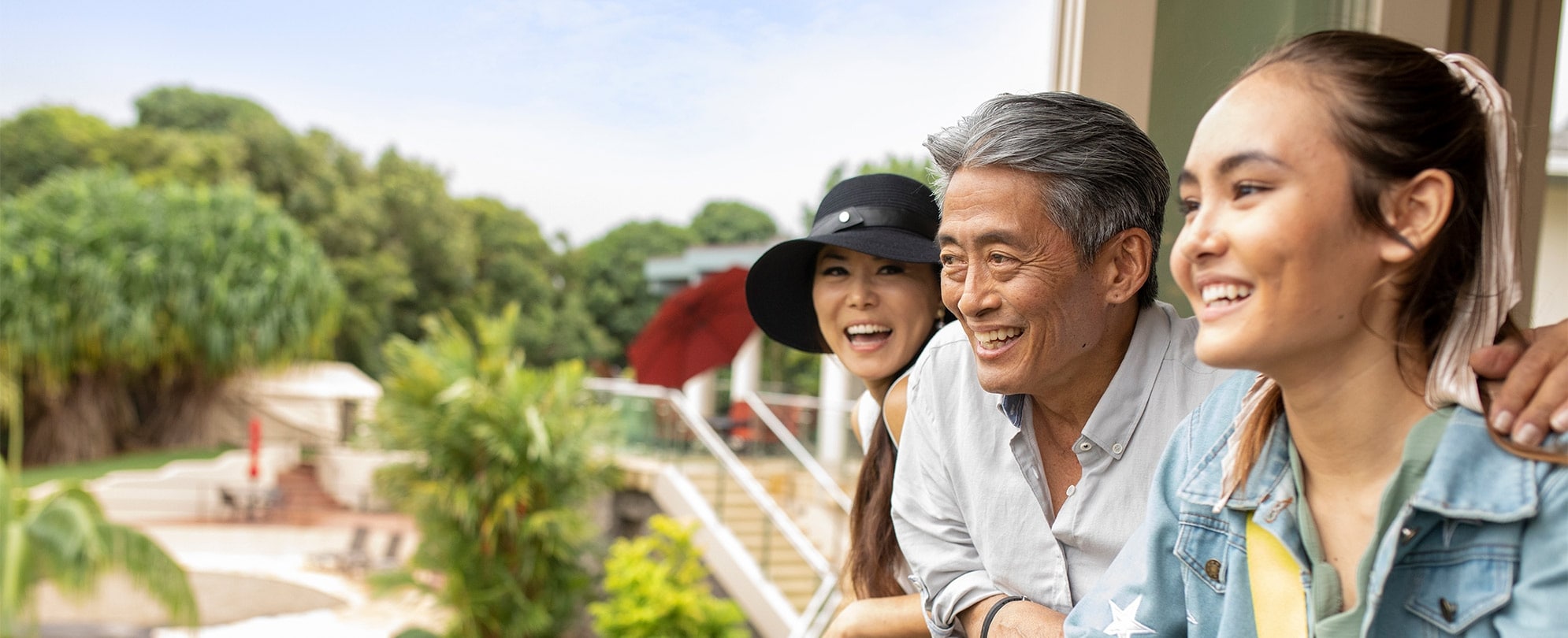 A man and his daughters looking out over their Club Wyndham resort balcony, after booking with owner priority access.