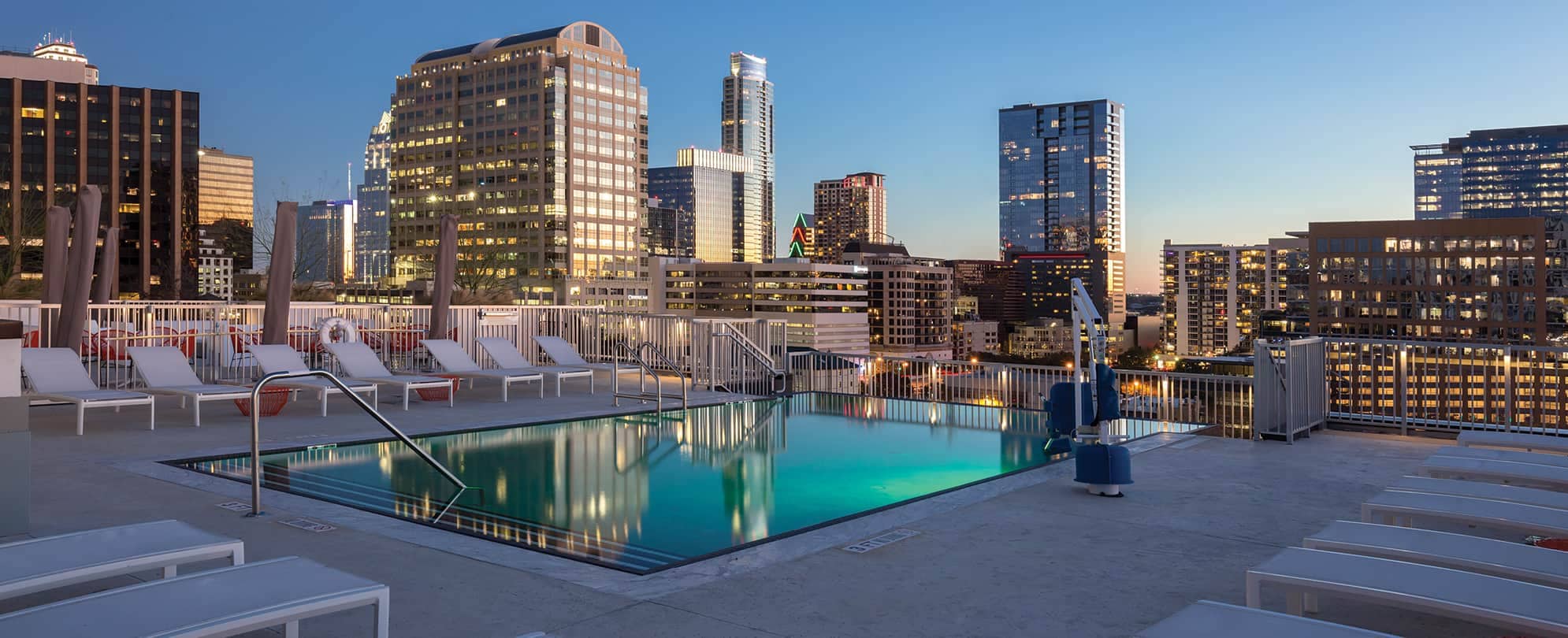 The rooftop pool and lounge area during sunset at Club Wyndham Austin in Austin, Texas