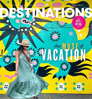 The cover of Destinations Magazine Fall 2022: The Muse of Vacations, showing a woman in front of a colorful wall mural.