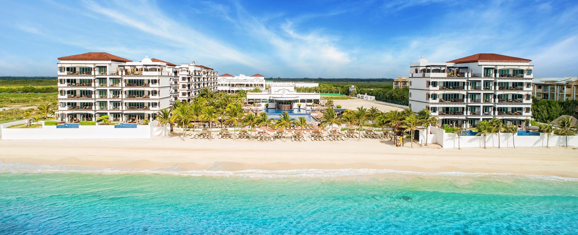 An aerial view of the Grand Residences Riviera Cancun resort and on-site beach in Puerto Morelos, Mexico.
