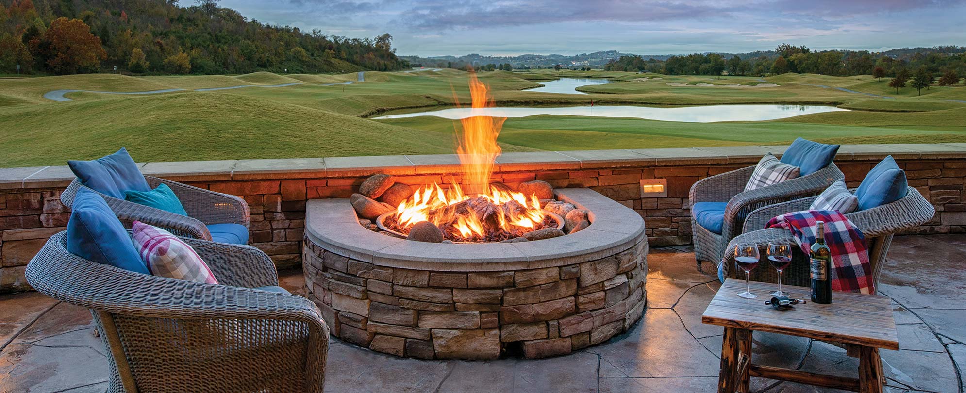 Chairs and wine surround a fire pit overlooking the golf course at Club Wyndham Great Smokies Lodge in Sevierville, Tennessee
