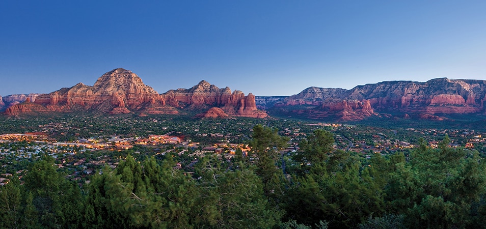 An aerial of Sedona, Arizona, and its surrounding red rock formations