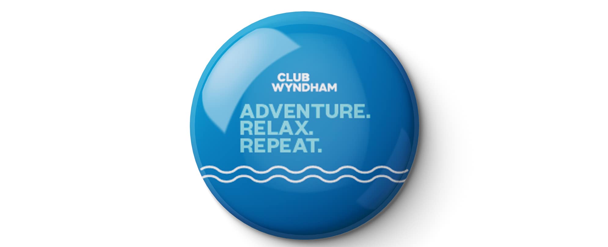 A blue "Adventure. Relax. Repeat." Club Wyndham pin