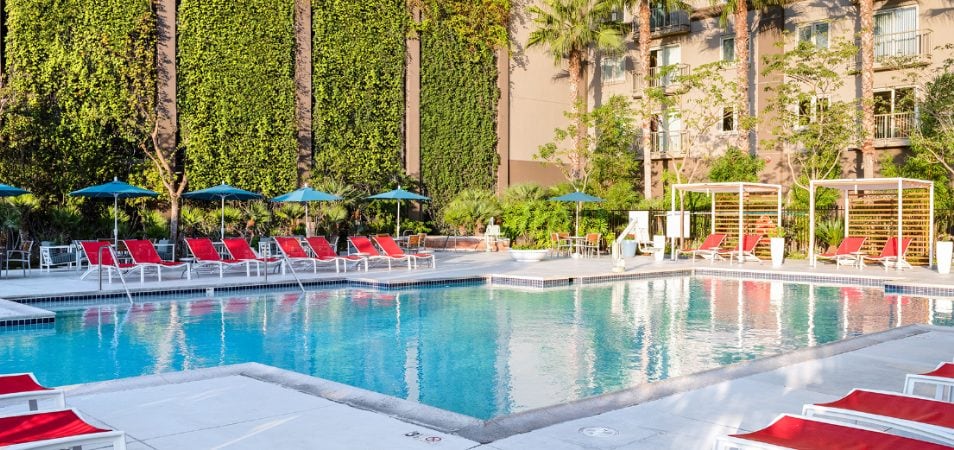 An outdoor pool surrounded by lounge chairs at WorldMark /Club Wyndham Anaheim, a timeshare resort in California.