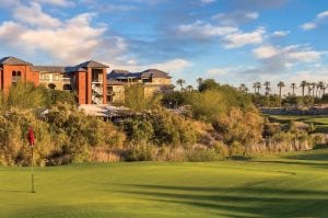 The green of a golf course, with Club Wyndham and WorldMark Indio timeshare resort in the distance.
