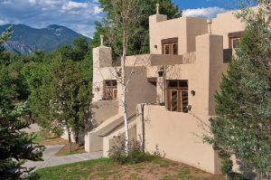 The exterior of Club Wyndham Taos, a timeshare resort in Taos, New Mexico, surrounded by trees and mountains.